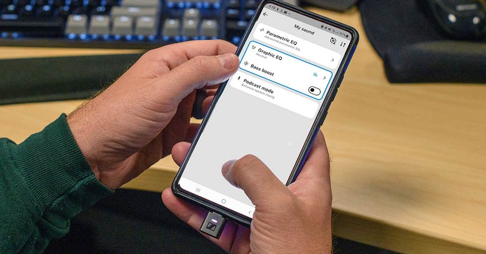 Sennheiser HDB 630 Bluetooth adapter shown plugged into phone