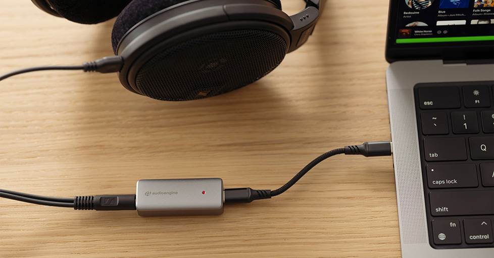 Audioengine HXL DAC shown with headphones and laptop