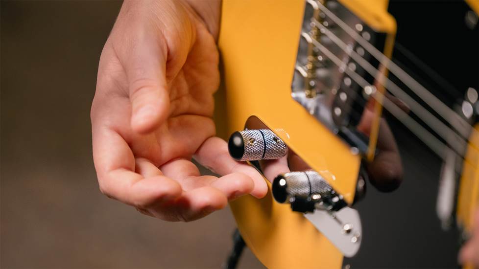 close of Telecaster controls with hand adjusting the tone control