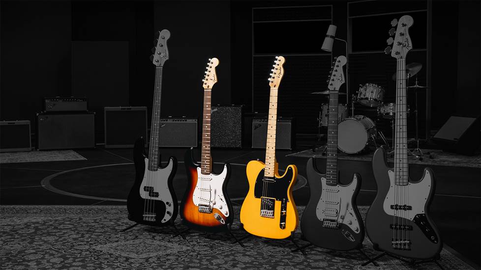 Row of guitars in a studio setting with all but 2 darkened and desaturated