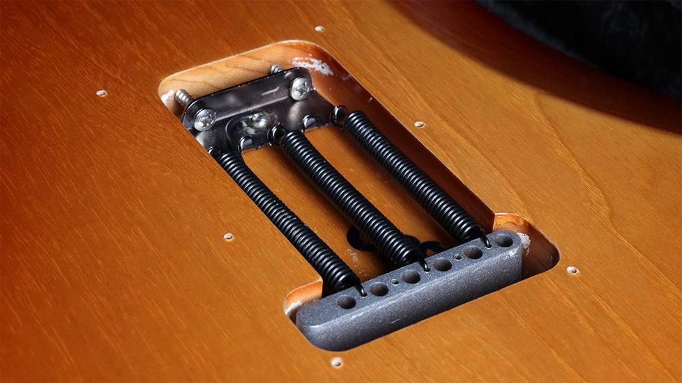 Stratocaster guitar with back plate removed showing trem springs