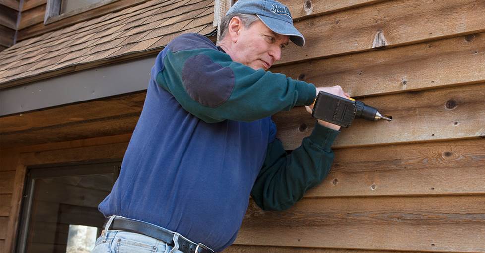 Norm drilling to prep for installing outdoor speakers
