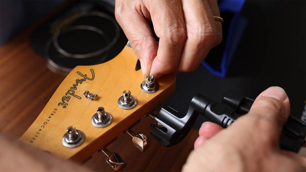 winding a guitar string to tune