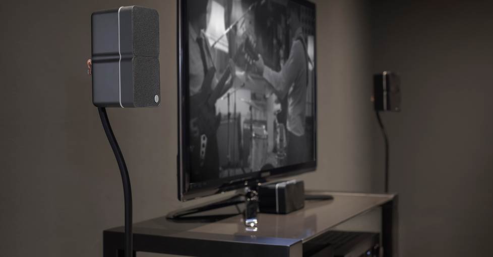 A Cambridge Audio Minx ultra-compact speaker sitting under a TV