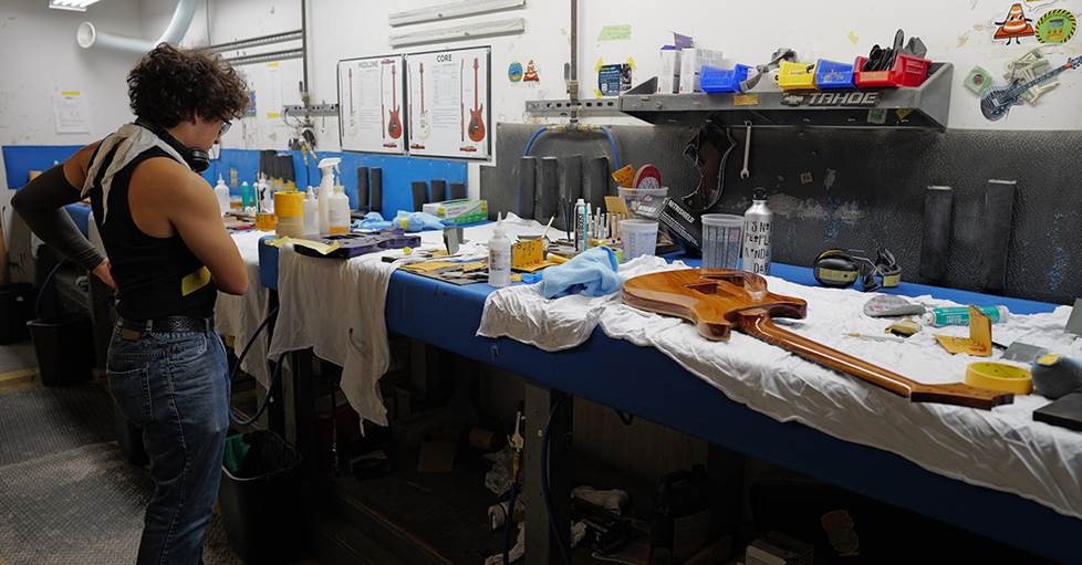 A worker at PRS's Stevensville plant taping off guitar bodies before installing electronics and hardware.