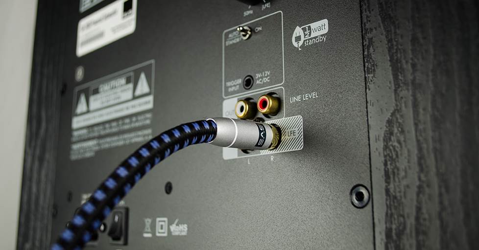 A subwoofer cable connected to the LFE input on a powered subwoofer