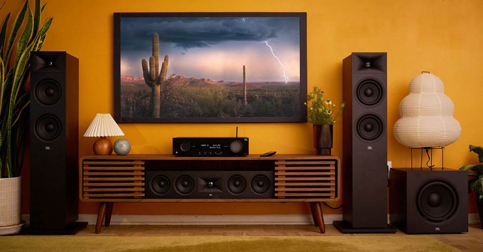 A JBL receiver and speakers with a wall-mounted TV