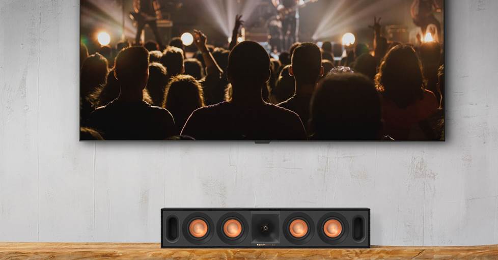 a klipsch center channel speaker, below a TV
