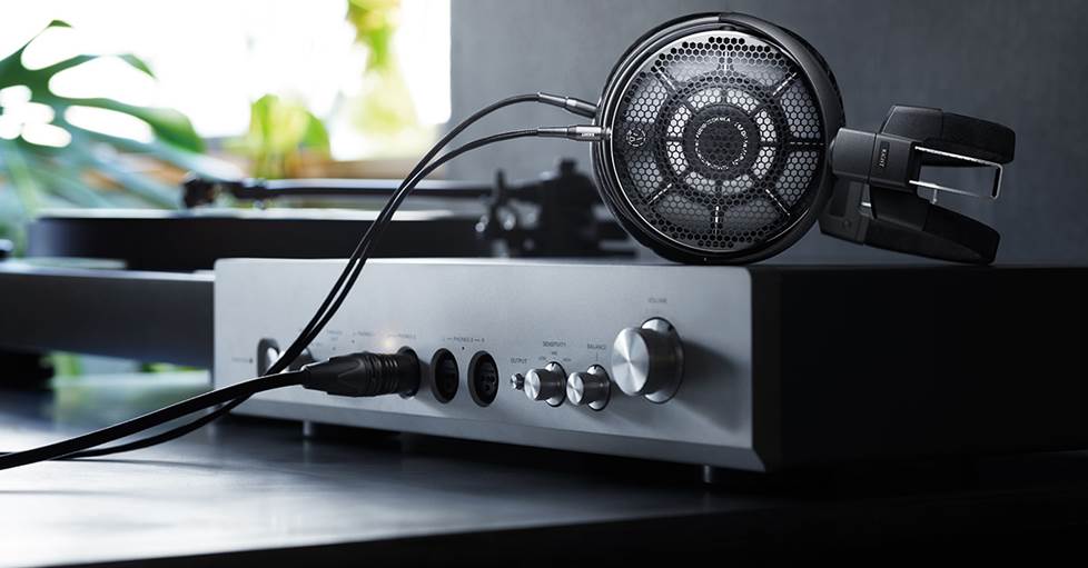Audio-Technica ADX7000 open-back wired headphones connected to a headphone amp