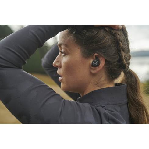 Woman wearing JBL UA True Wireless Streak earbuds