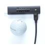 Roku 3821R Streaming Stick 4K+ Golf ball shown for scale