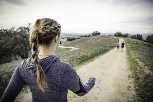 Woman wearing JBL Reflect Mini BT