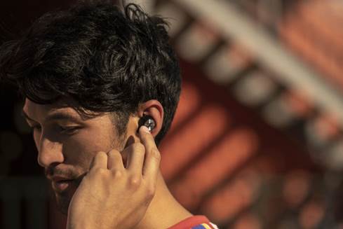 Person wearing Momentum True Wireless earbuds