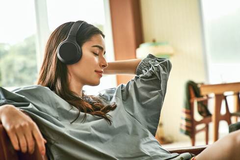 Woman wearing the Sony WH-XB700 EXTRA BASS headphones