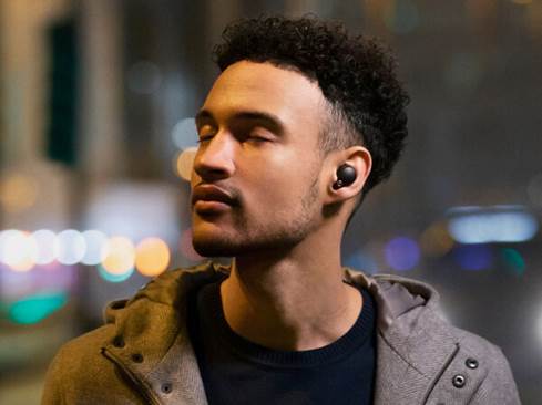 Man wearing Sony WF-1000XM4 earbuds.