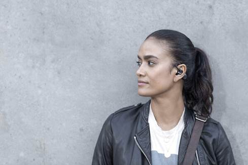 Woman wearing the Shure AONIC 215 earbuds