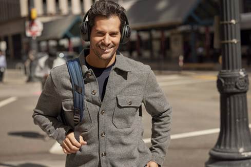 Man wearing JBL Tour One M2 headphones on the street