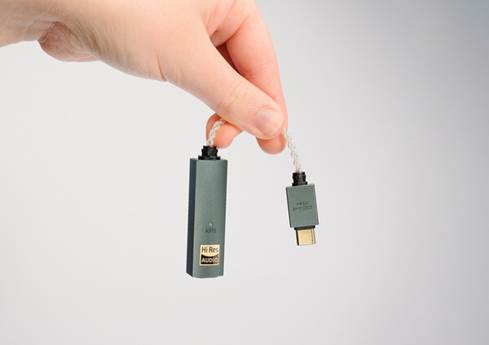 Person holding iFi Go Link Max in hand