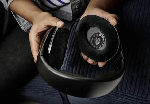 Person holding Sennheiser HD 550 open-back headphones in their hands.