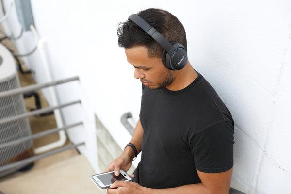 man wearing SoundLink around-ear wireless headphones