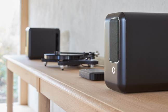 A pair of Q Active 200 speakers shown alongside a turntable.