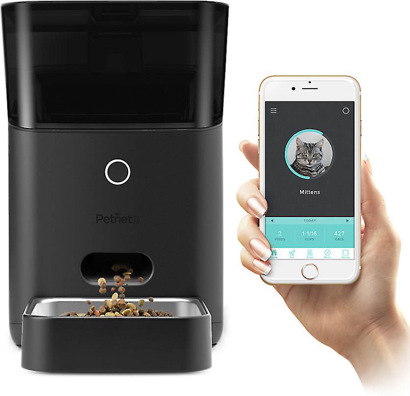 Photo of the Petnet Smart Feeder being controlled by a phone.