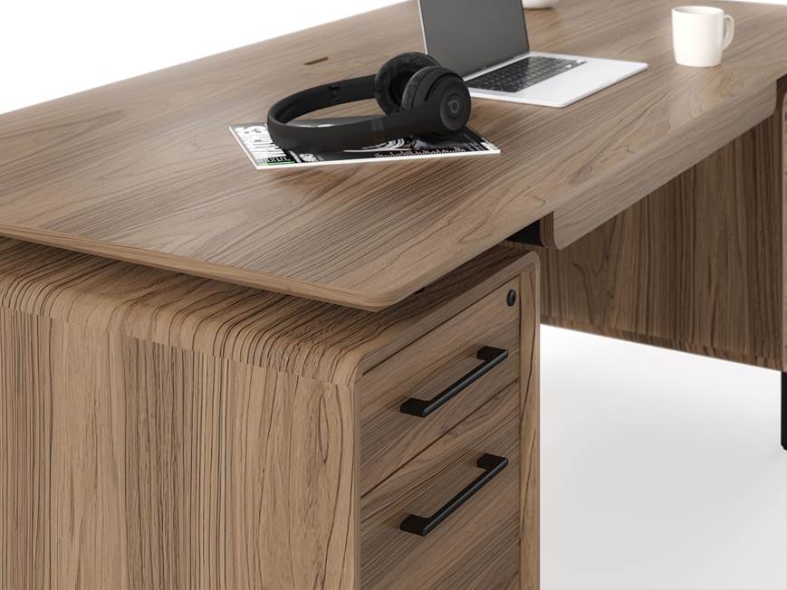 Top of desk with accessories like headphones and magazine