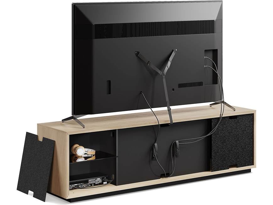 TV mounted above a wooden media console with black panels and open compartments