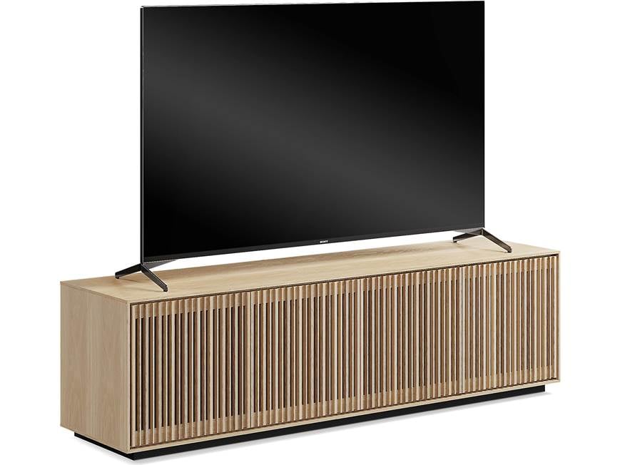 Television on top of a wooden media console with slatted front