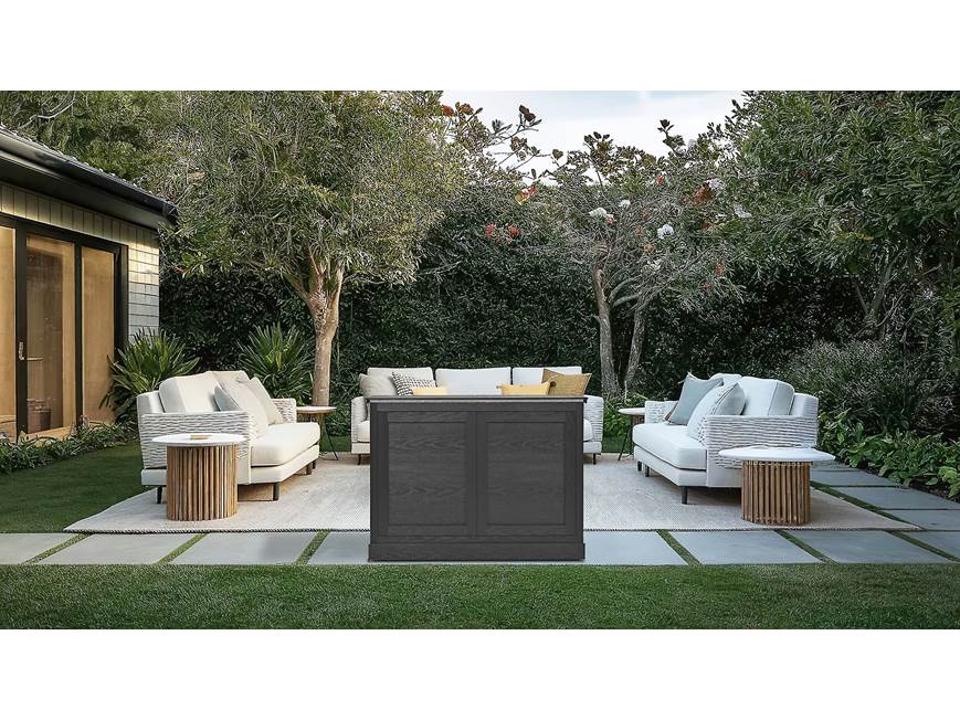 Outdoor TV lift cabinet in a landscaped backyard