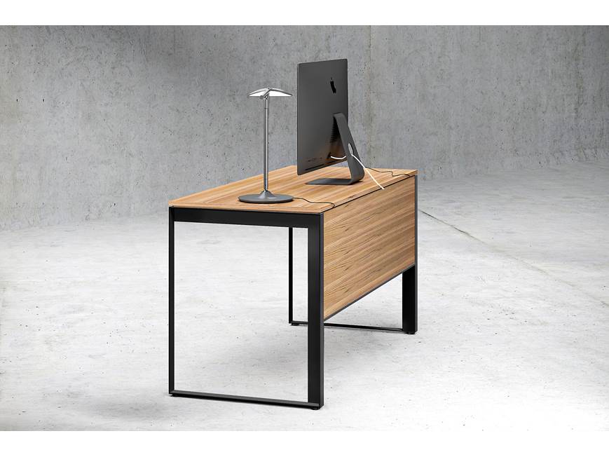Desk with wood top and black metal legs, computer setup