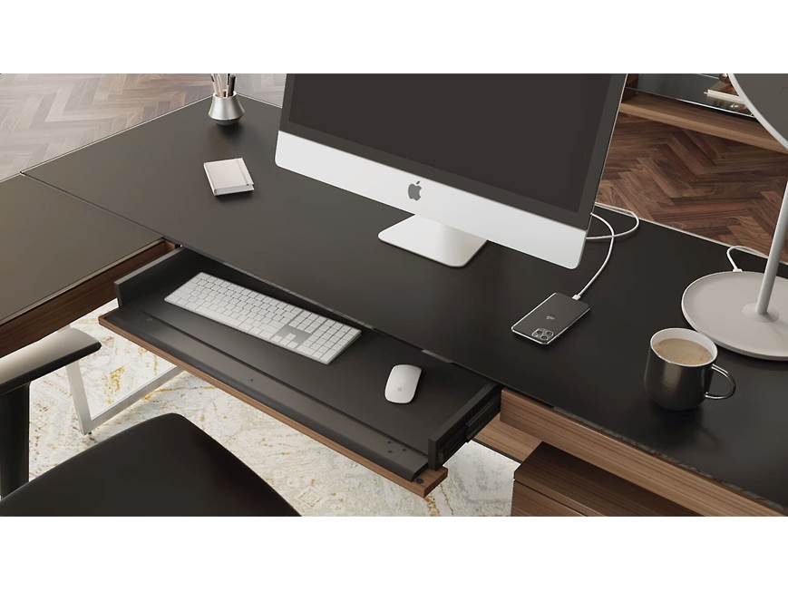 Desk with computer and accessories in a workspace