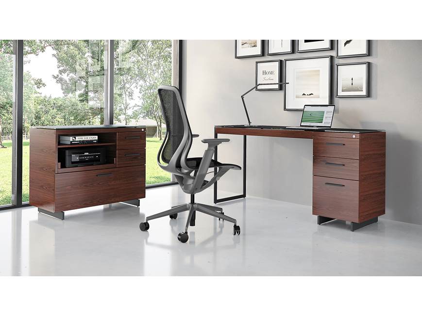 Office setup with desk, filing cabinet, and hutch in an office space