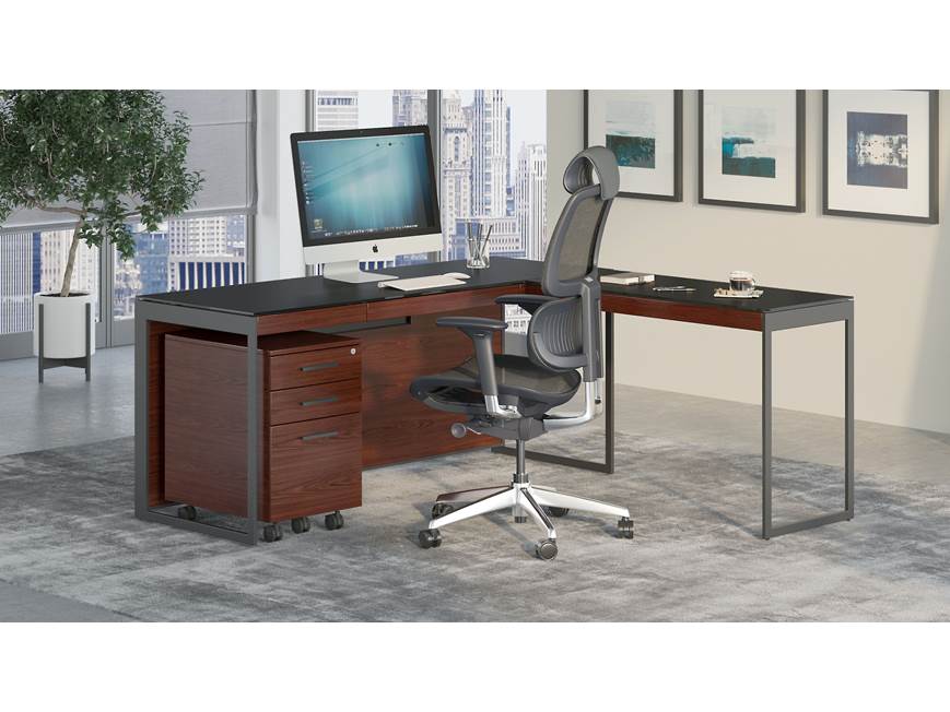 Executive desk with black top and walnut drawers in modern office