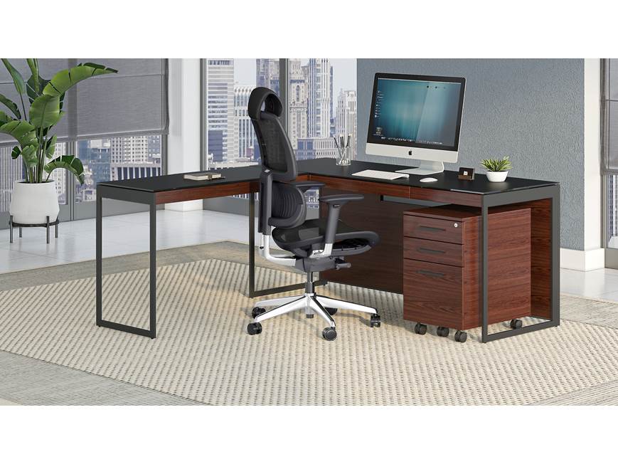 Desk with natural wood drawers and black top in office
