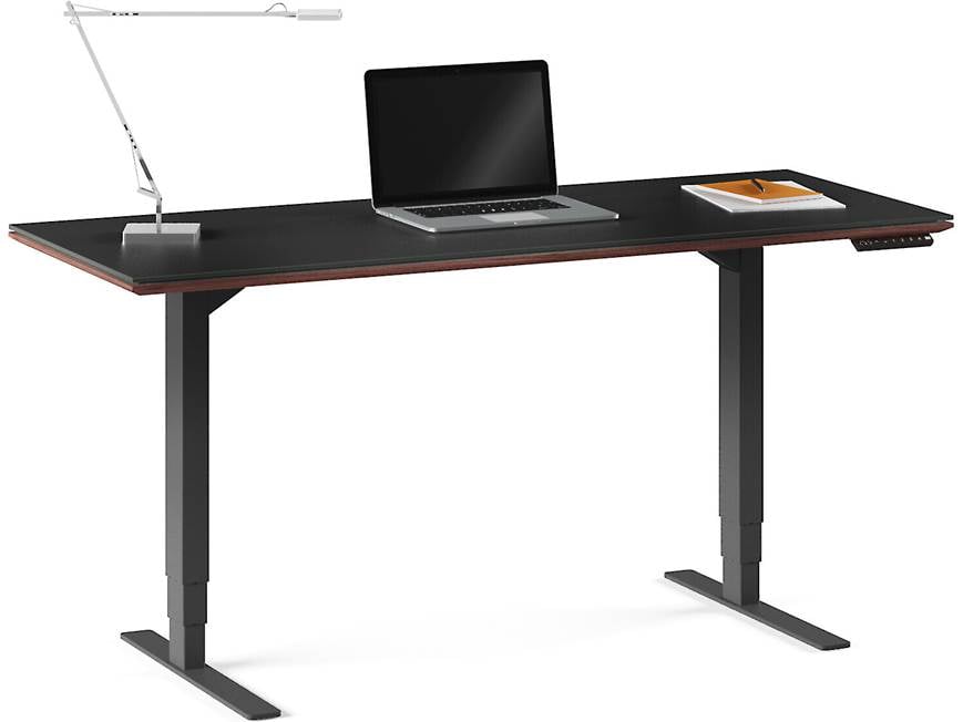 Desk with laptop, notebook, and lamp