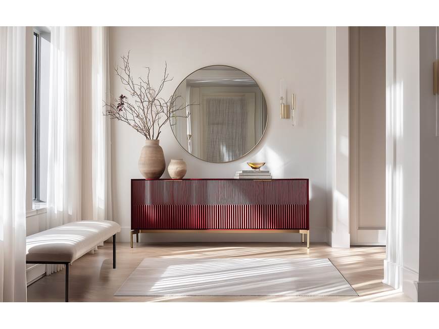 Sideboard in a bright room with mirror and plant