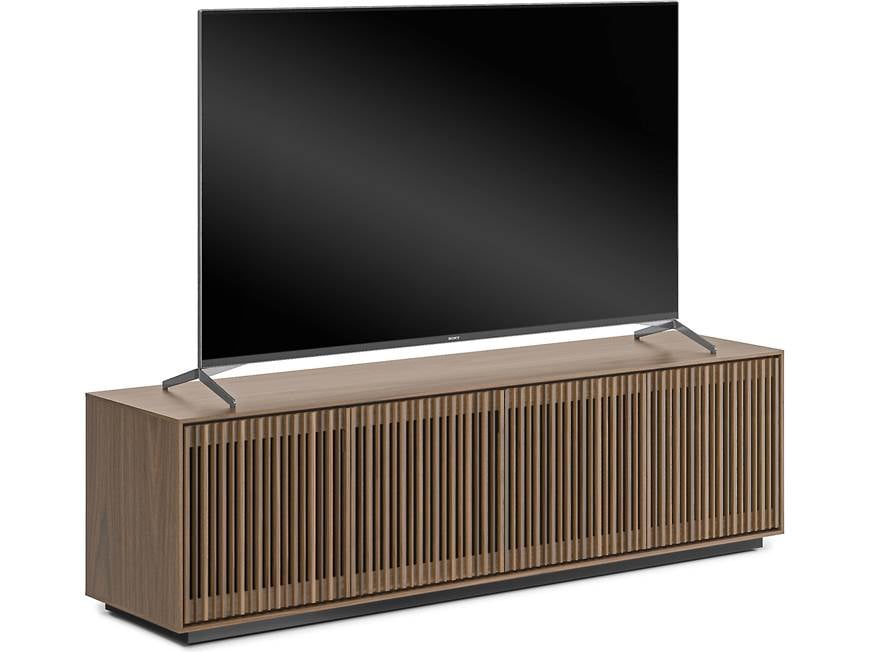 TV on top of wooden cabinet with slatted front