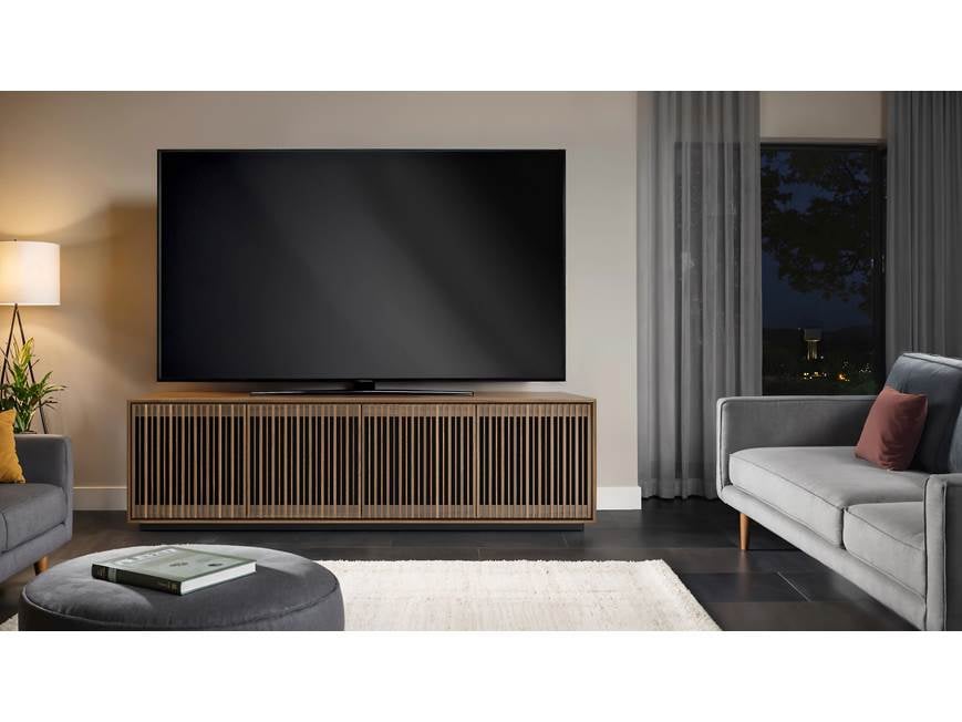 Walnut TV stand in living room with sofa
